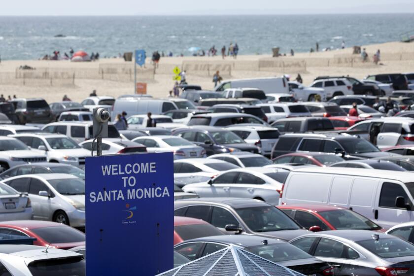 SANTA MONICA, CA - APRIL 05: The parking lot at the Santa Monica Pier was nearly full on Monday, April 5, 2021 as Los Angeles County entered the less strict orange tier allowing more places to open and inviting more people to venture outdoors. (Myung J. Chun / Los Angeles Times)