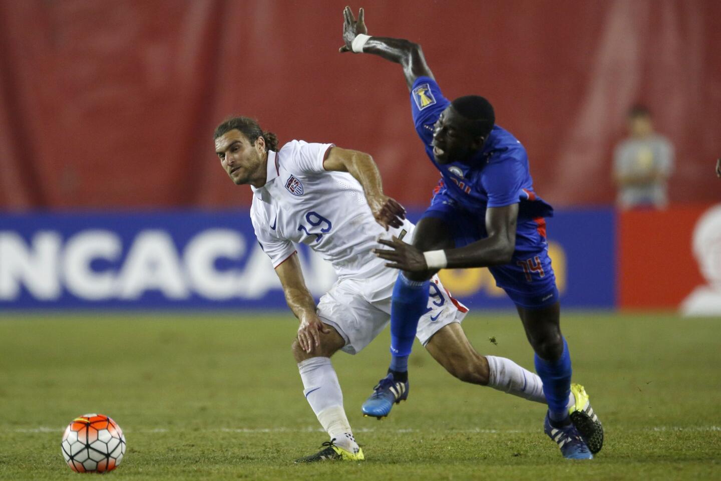 United States' Graham Zusi (19) battles Haiti's James Marcelin (14) during the CONCACAF Gold Cup match between the United States and Haiti, July 10, 2015, in Foxborough, Massachusetts.