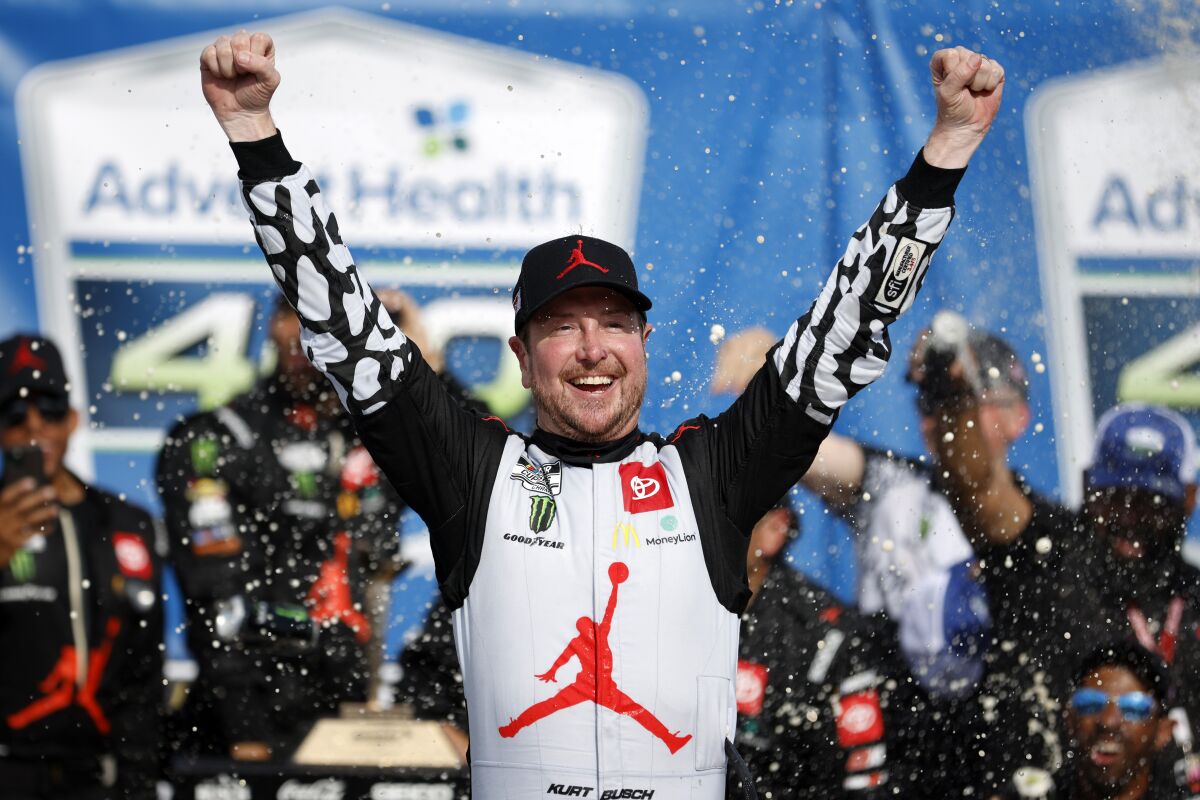 Kurt Busch celebrates in victory lane after winning a NASCAR Cup Series.