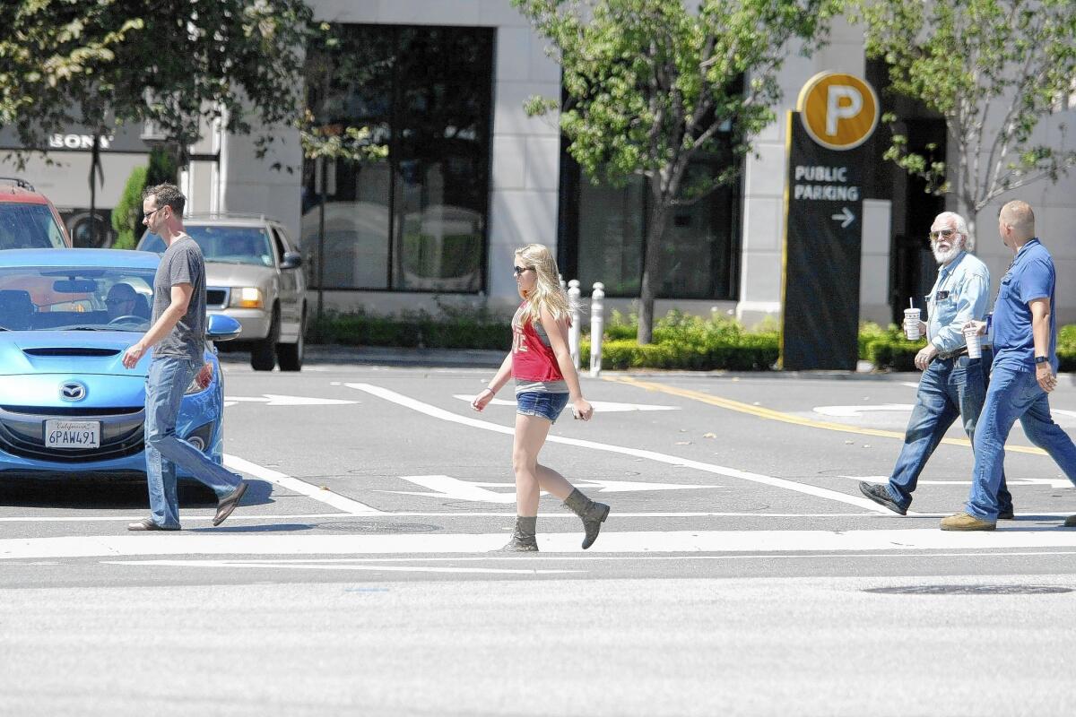 People cross the street at Harvard St. and Brand Blvd. in Glendale on Wednesday, Aug. 27, 2014.