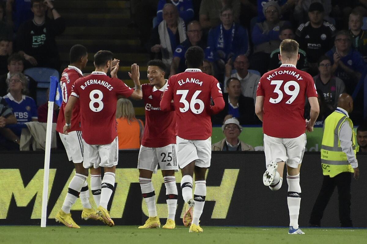 Manchester United's Jadon Sancho, center, celebrates after scoring the opening goal of his team during the English Premier League soccer match between Leicester City and Manchester United at King Power stadium in Leicester, England, Thursday, Sept. 1, 2022. (AP Photo/Rui Vieira)