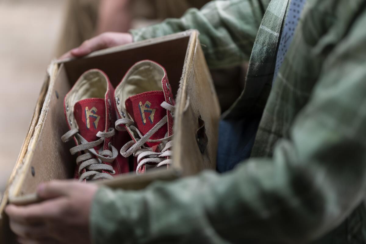 A pair of red sneakers in a box.
