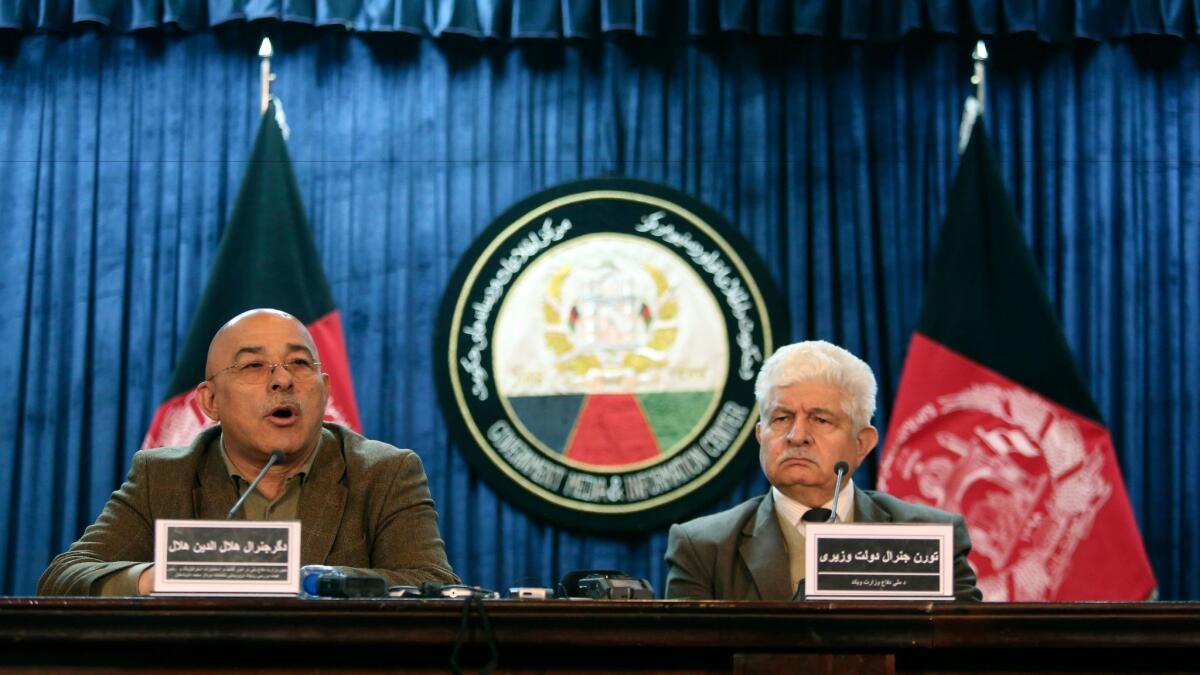 Lt. Gen. Helaludin Helal, Afghanistan's deputy defense minister, left, and defense ministry spokesman Dawlat Waziri brief reporters on the investigation into the attack on a Kabul military hospital.