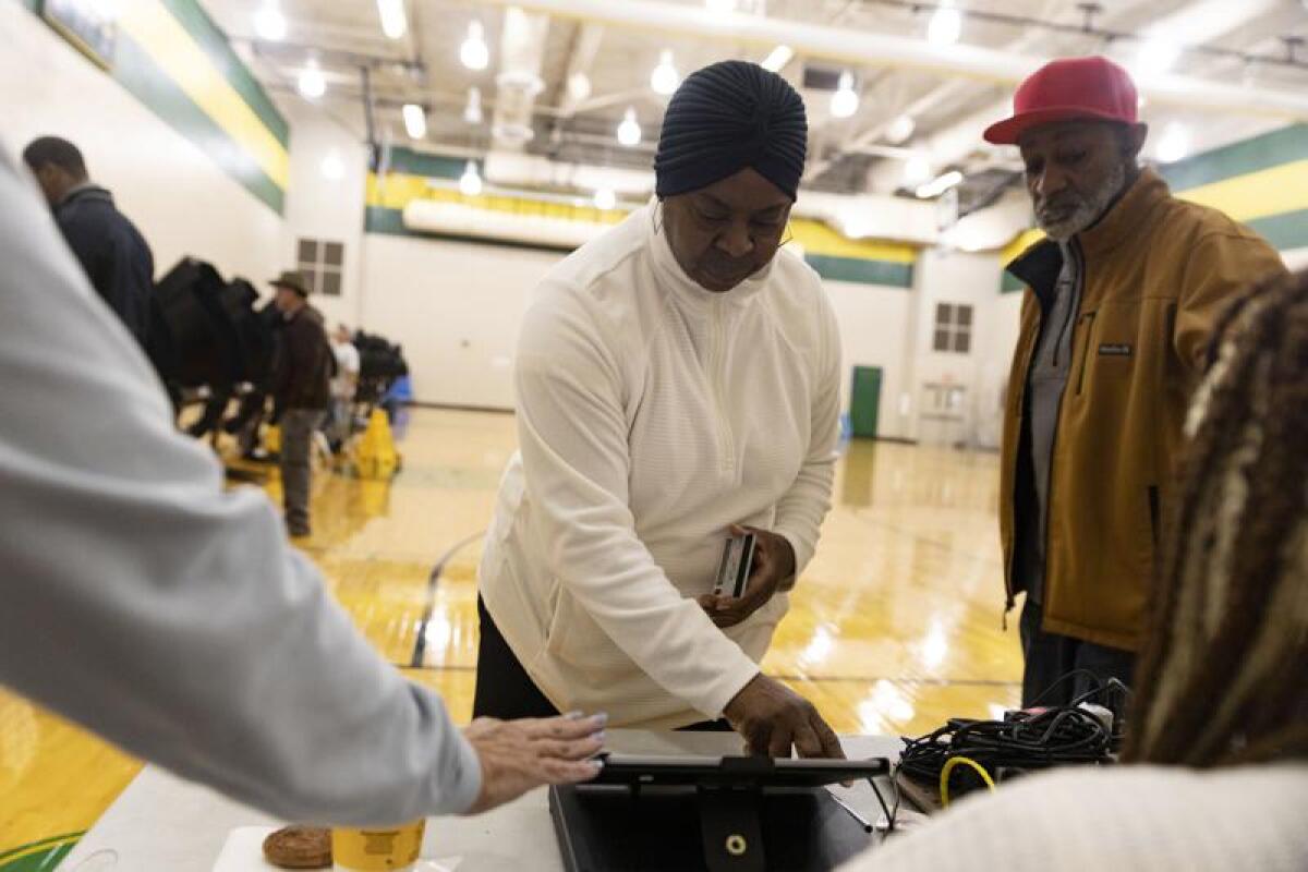 A couple check in at a voting center