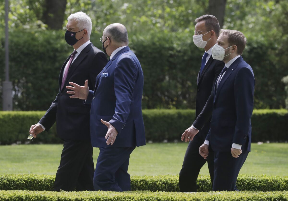 Slovak Foreign Minister Ivan Korcok,left,, Polish Foreign Minister Zbigniew Rau ,Hungarian Foreign Minister Peter Szijjarto and Czech Republic Foreign Minister Tomas Petricek ,right, walk after the foreign ministers of the Visegrad Group ,V4, meeting in Lodz, Poland, Friday, May 14, 2021.(AP Photo/Czarek Sokolowski)