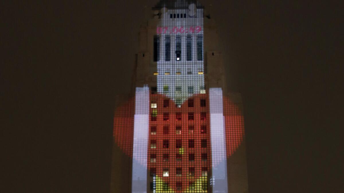 Images are projected on City Hall in a rehearsal Tuesday for Grand Park's New Year's Eve celebration.