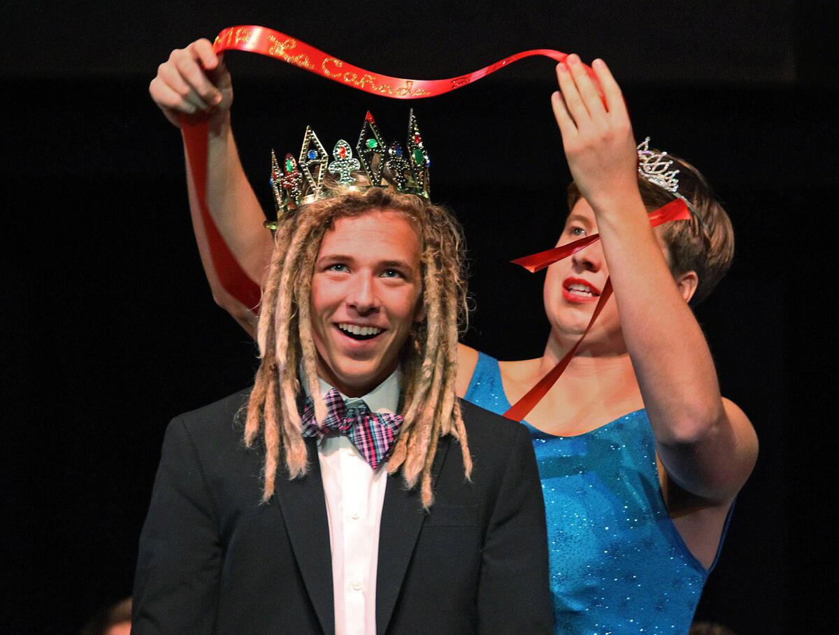 Griffin Van Amringe is crowned and sashed the winner of the contest by Reed Buck who is wearing a tiara and a dress in the first ever Mr. La Canada beauty pageant hosted by the La Canada High School' ASB on Friday, March 14, 2014. The pageant, which was at La Canada High School, was a fundraiser for the St. Baldrick's Foundation to Conquer Childhood Cancers.