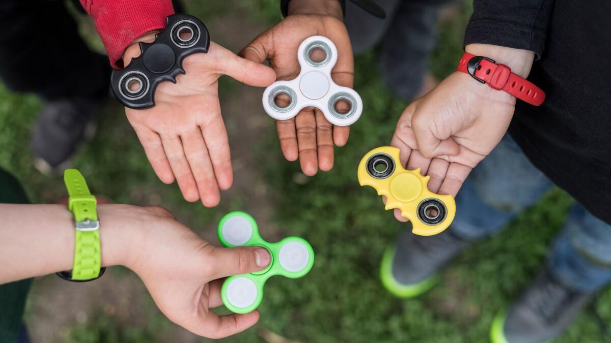Children hold fidget spinners at a school in Bern, Switzerland on May 18.