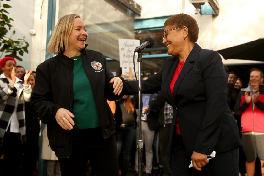 VENICE, CA - JANUARY 13, 2023 - - Los Angeles City Council Member Traci Park, left, and Los Angeles Mayor Karen Bass enjoy a light moment at a thank you reception for overseeing efforts to move 96 homeless into temporary housing at the Rose Cafe in Venice on January 13, 2023. Bass' Inside Safe initiative has moved scores of homeless people indoors over the past few weeks. (Genaro Molina / Los Angeles Times)