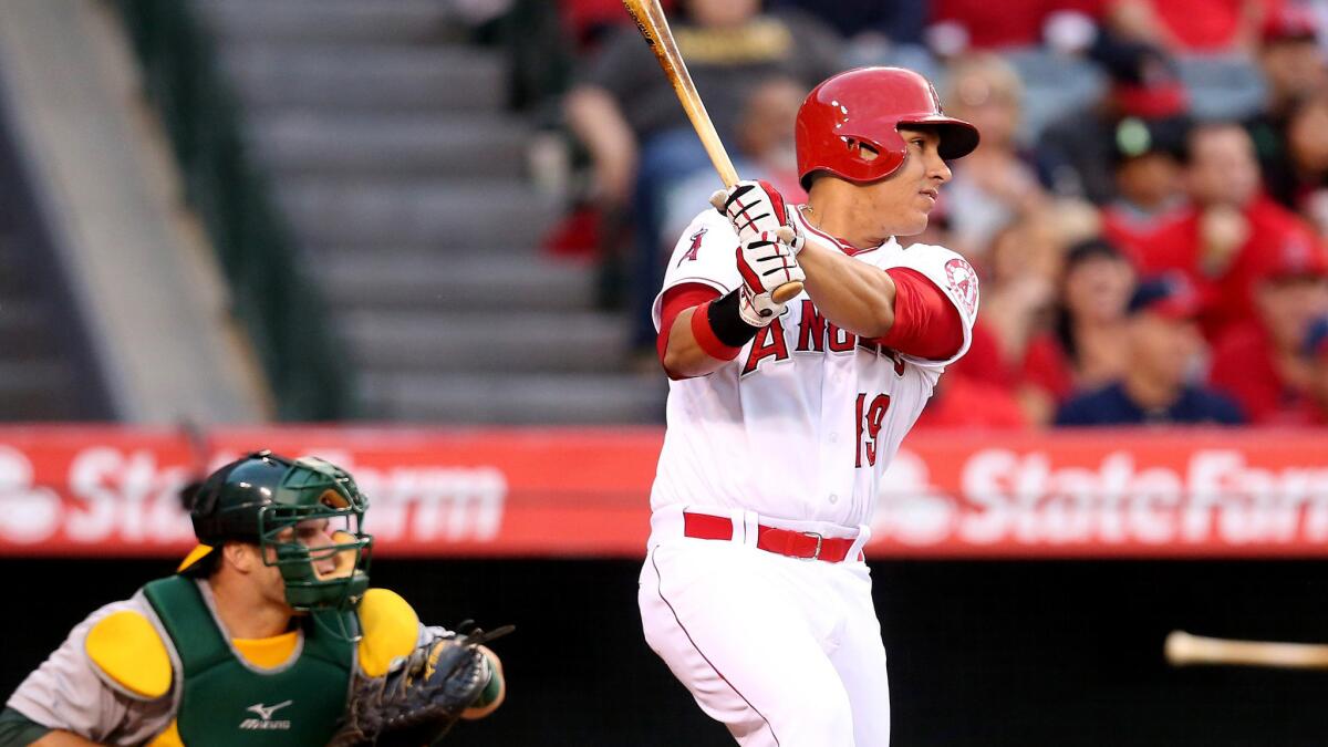 Angels left fielder Efren Navarro connects for a run-scoring single against the A's in the second inning Friday night in Anaheim.