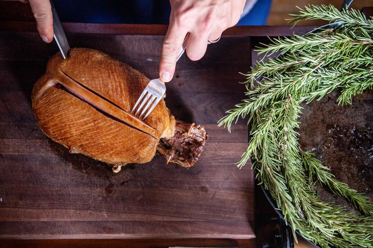 Dave Beran demonstrates how he prepares the tableside pressed duck.