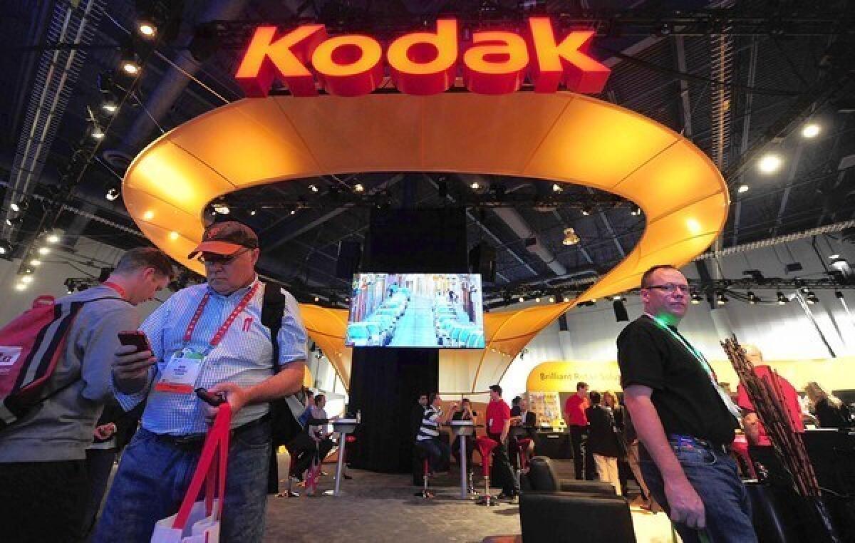 A 23% cut in jobs will leave Kodak with 13,100 workers. Above, visitors to Kodak¿s display at this year¿s Consumer Electronics Show in Las Vegas.