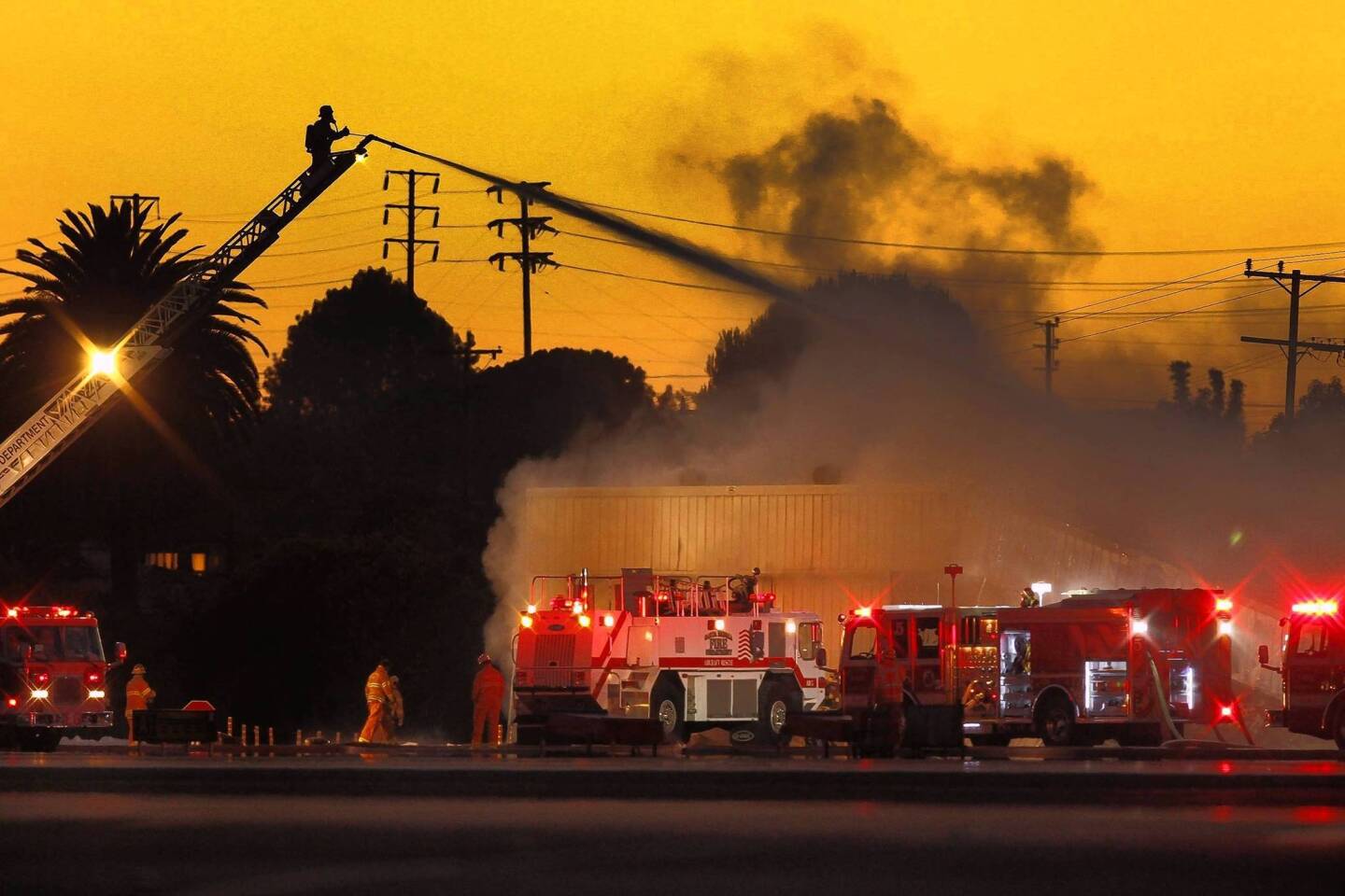 Firefighters battle a blaze at Santa Monica Airport that began when a small jet veered off the runway and crashed into a hangar. The fire spread to two other buildings.