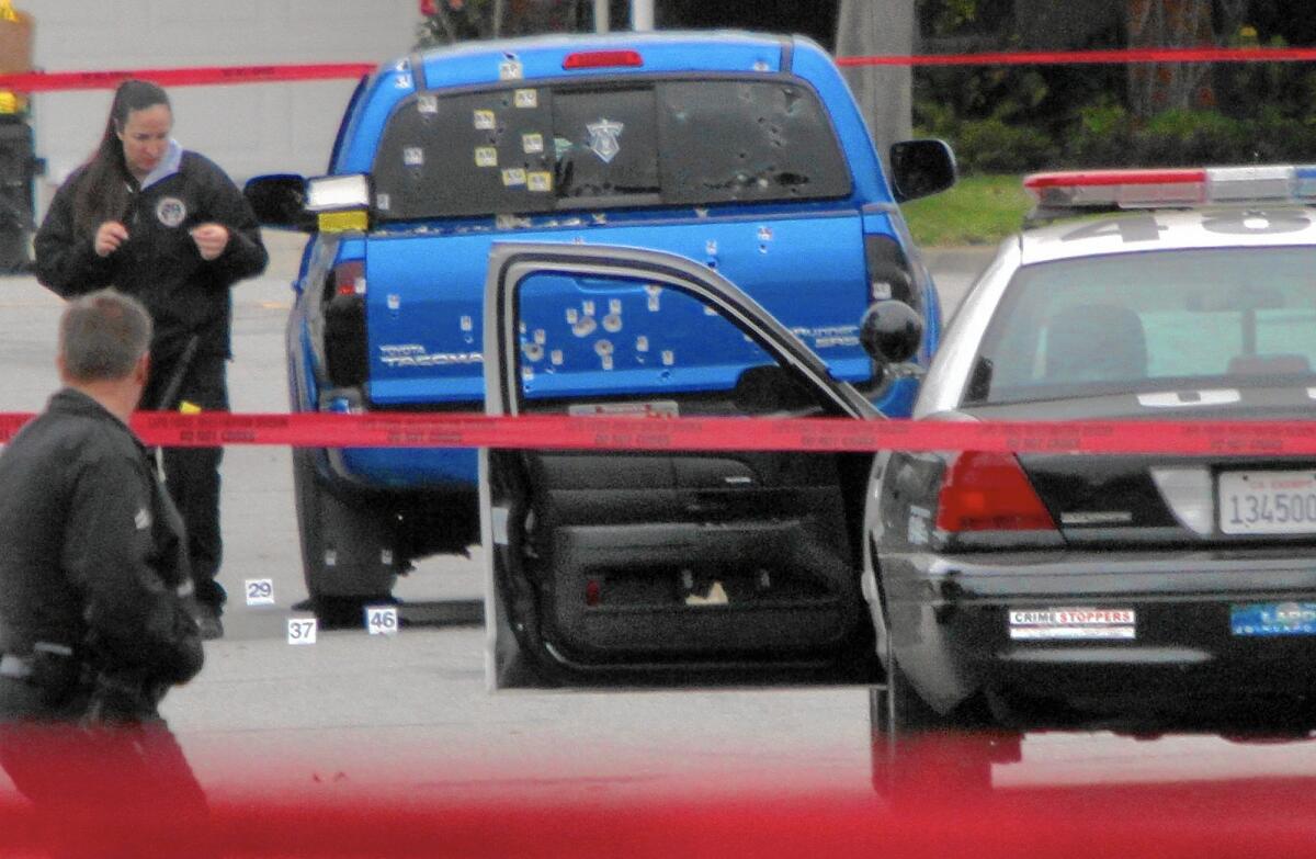 Police inspect a pickup riddled with bullets in Torrance on Feb. 7, 2013. Two women in the truck delivering newspapers were mistaken for Christopher Dorner, a rogue former cop.