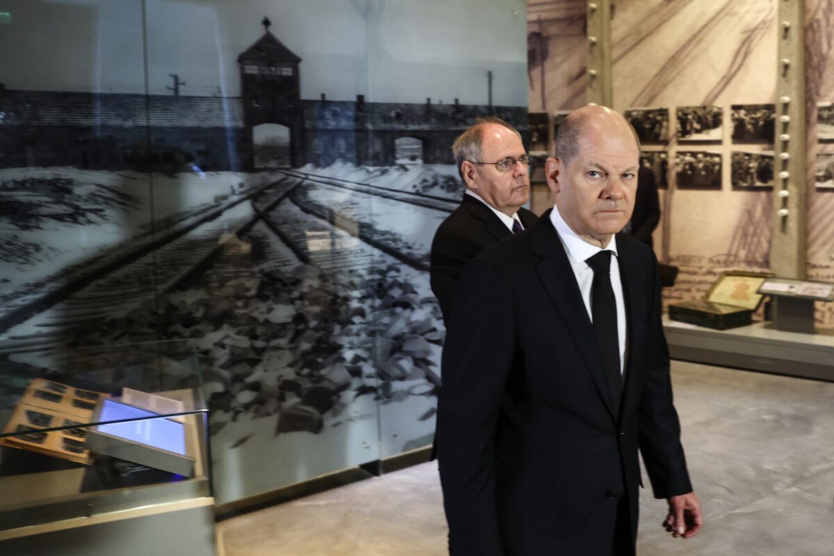 German Chancellor Olaf Scholz, right, tours the Yad Vashem World Holocaust Remembrance Center during a state visit, in Jerusalem, Wednesday, March 2, 2022. (Ronen Zvulun/Pool Photo via AP)