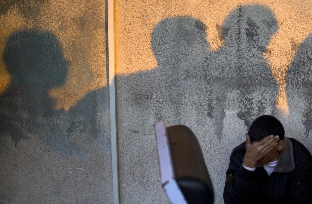 A relative of a 3-year-old Palestinian girl who was killed in an Israeli airstrike grieves outside a hospital morgue in Deir al Balah, in the central Gaza Strip.