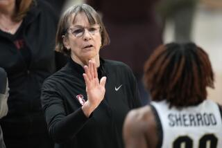 Stanford coach Tara VanDerveer congratulates Colorado guard Jaylyn Sherrod after their game went to double overtime