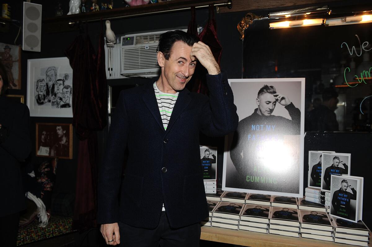 Actor Alan Cumming posing at the book launch party for "Not My Father's Son."