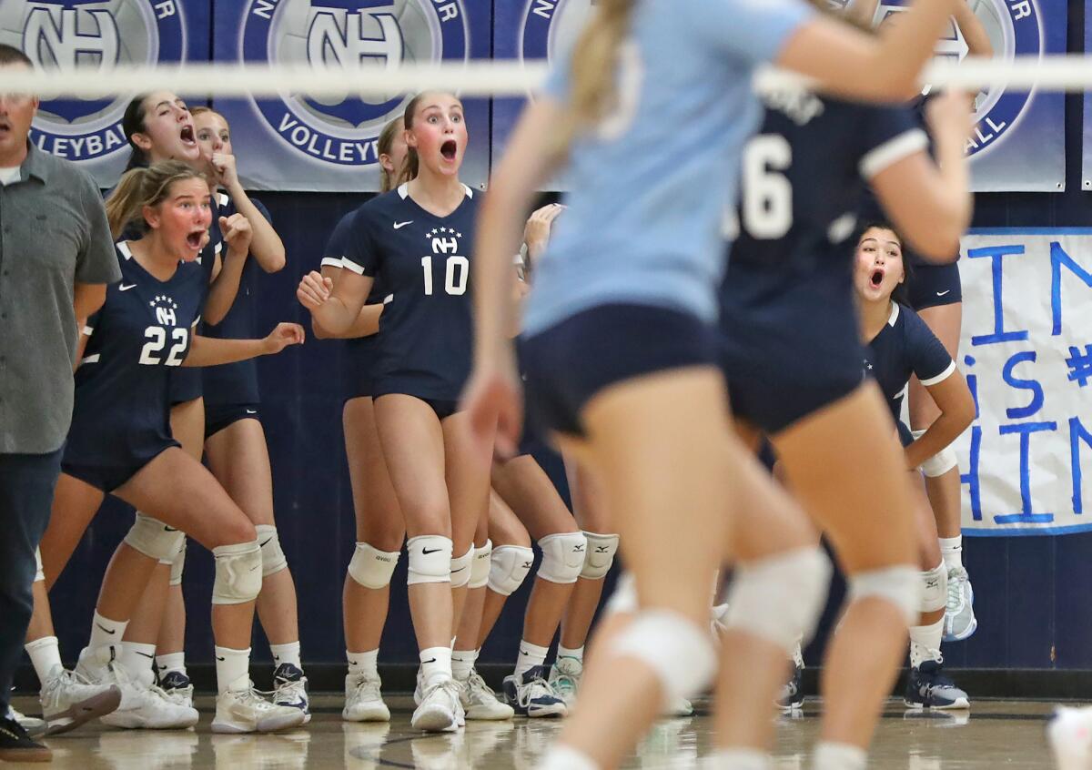 Newport Harbor's Evie Jorgensen (22) and Reagan Bland (10) react.