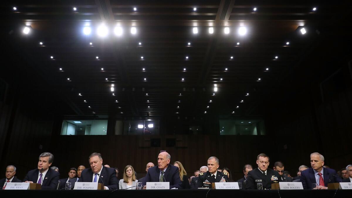 FBI Director Christopher A. Wray, CIA Director Mike Pompeo, Director of National Intelligence Dan Coats, from left, and leaders of other U.S. intelligence agencies during testimony Wednesday.