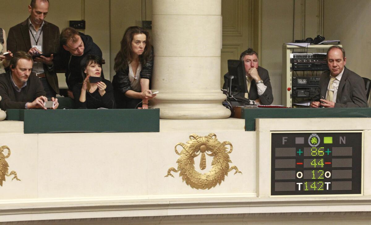 Journalists look at the electronic voting board as Belgian politicians vote in favor of the bill on child euthanasia in Brussels on Thursday.