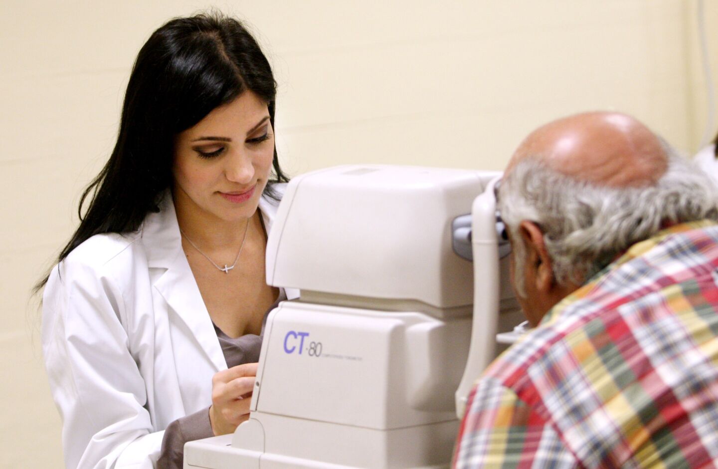 Susie Haroutounian, student at West Coast University, gives a glaucoma test to an attendee at the Sixth Annual Glendale Health Festival at the Glendale Civic Auditorium in Glendale on Saturday, November 7, 2015.