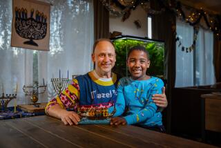 Studio City, CA - December 05: Adam Kulbersh, founder of Project Menorah, and his 6-year-old son Jack pose for a portrait on Tuesday, Dec. 5, 2023 in Studio City, CA. (Jason Armond / Los Angeles Times)