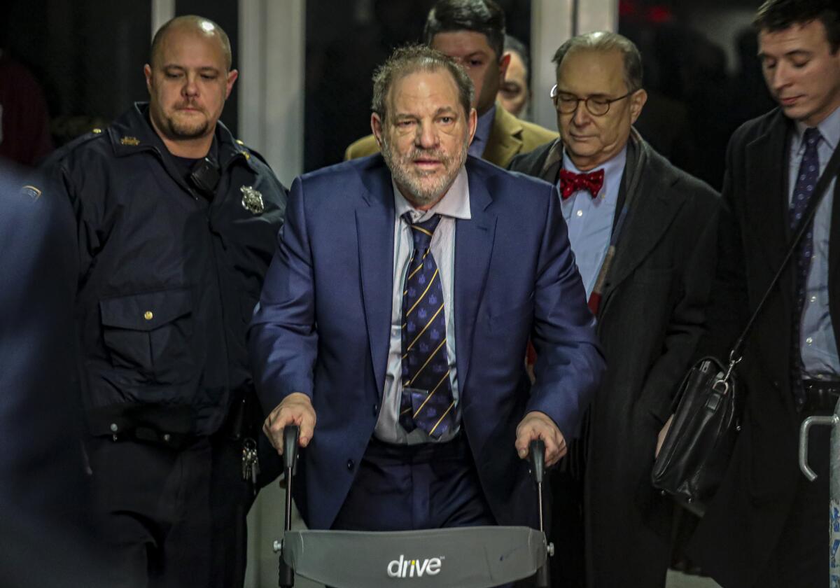 Harvey Weinstein, second from left, leaves Manhattan Criminal Court after prosecutors completed their closing arguments in his rape trial on Friday.
