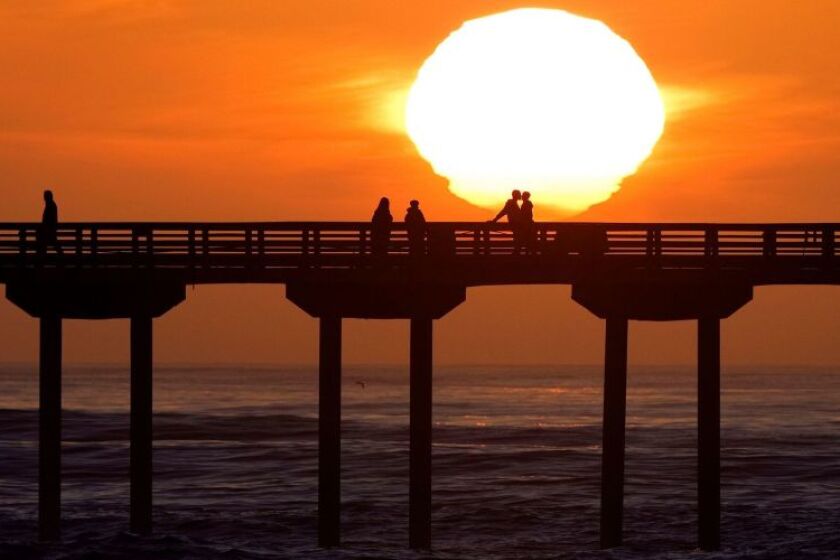 Sunsets behind the Ocean Beach Pier after a big surf day.