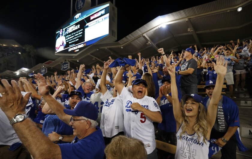 Dodgers fans cheer in the left field pavilion at Dodger Stadium
