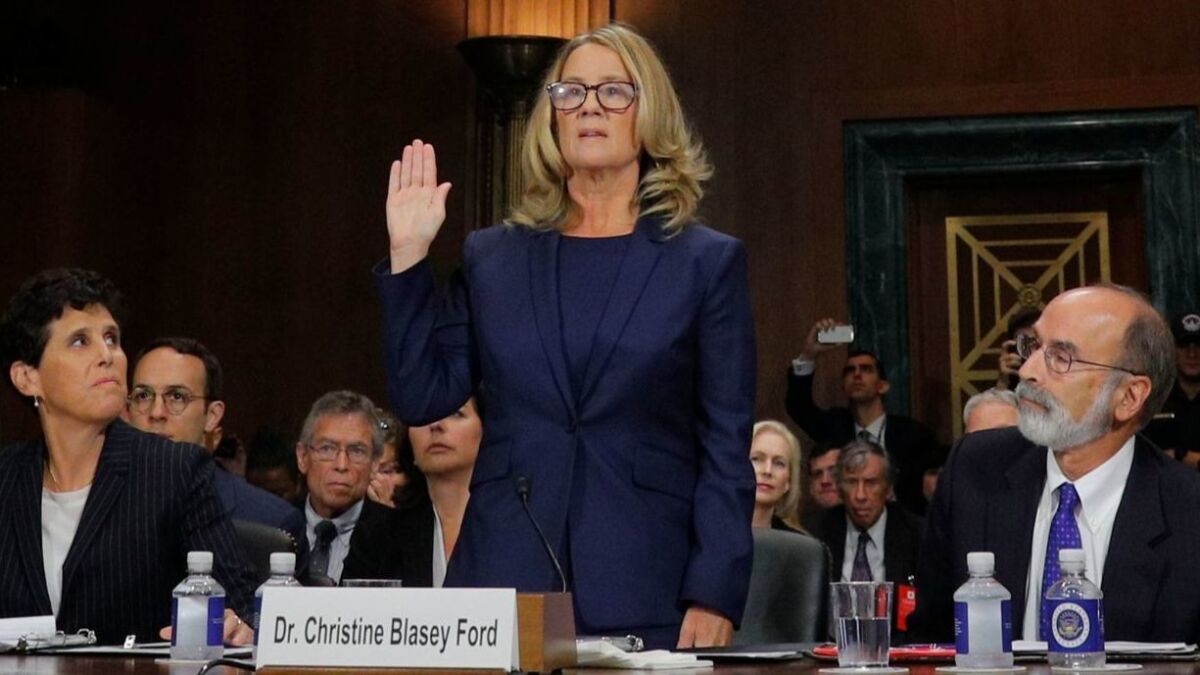 Christine Blasey Ford is sworn in before she begins her testimony to the Senate Judiciary Committee.