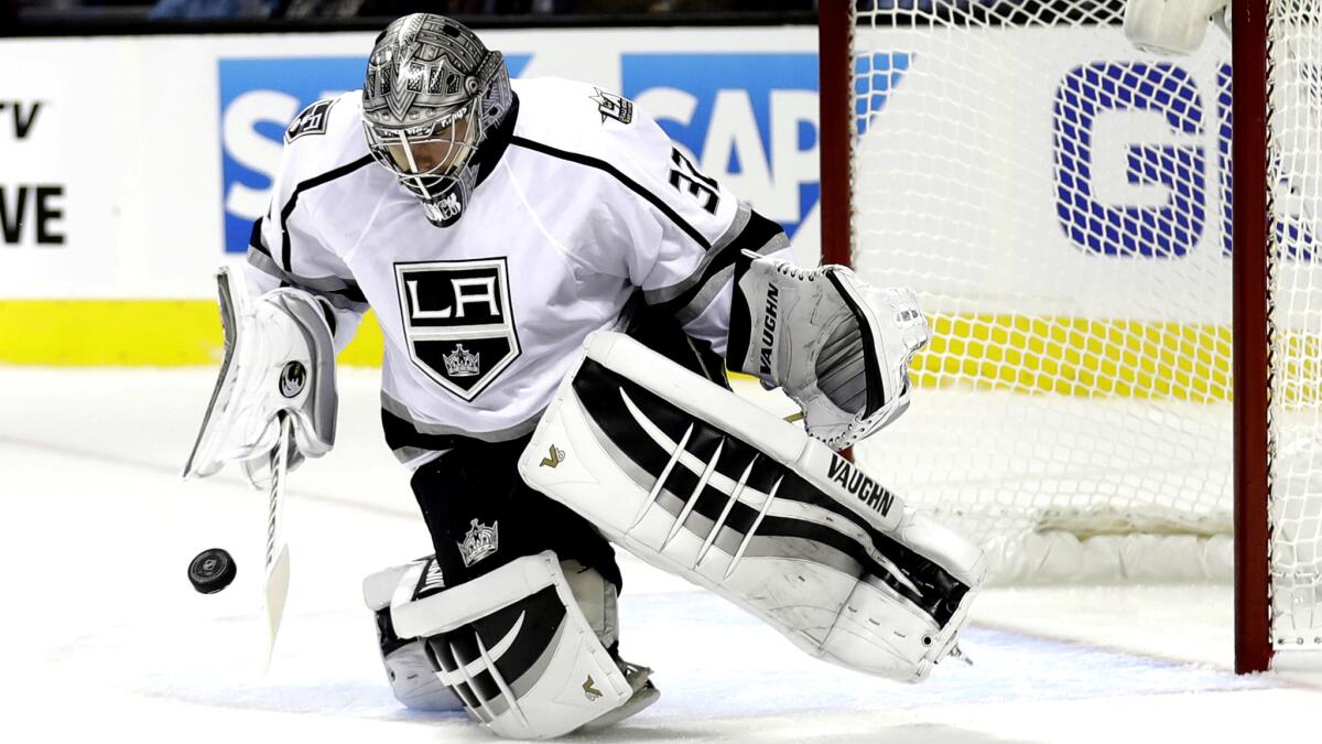 Kings goaltender Jonathan Quick stops a shot by the San Jose Sharks during the first period on Oct. 12.