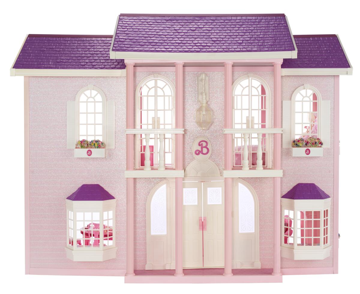 A pink 1990 Barbie dollhouse evokes a Southern McMansion with Classical columns and Italianate balustrades