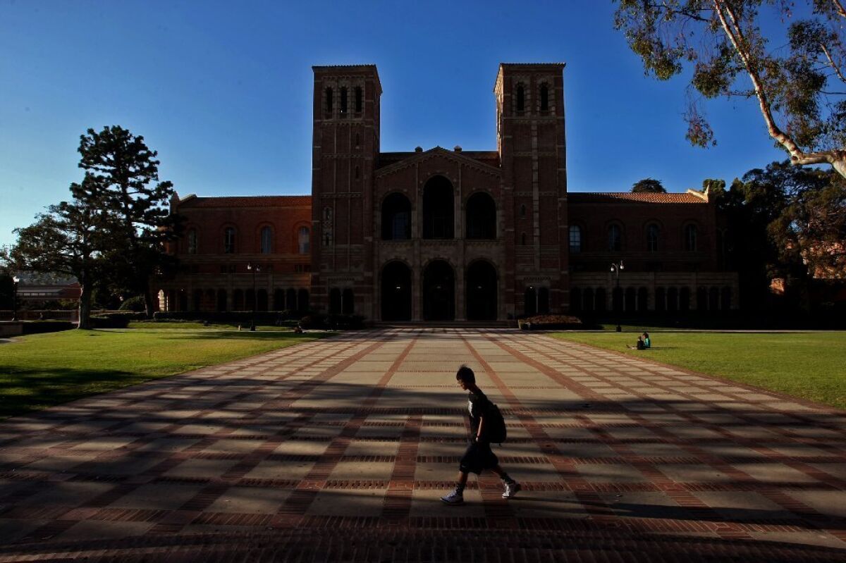 A student walks in the courtyard in front of Royce Hall on the UCLA campus in Westwood on August 7, 2013.