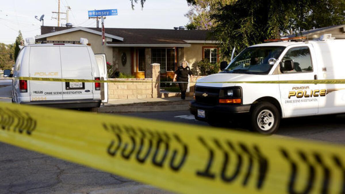 Police tape surrounds the scene at a home in the 2100 block of Ramsey Way in Pomona, where four bodies when discovered.