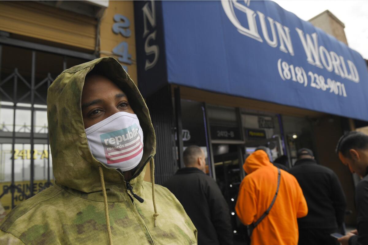 A gun store customer that gave his name only at John waits in line, Sunday, March 15, 2020, in Burbank, Calif.