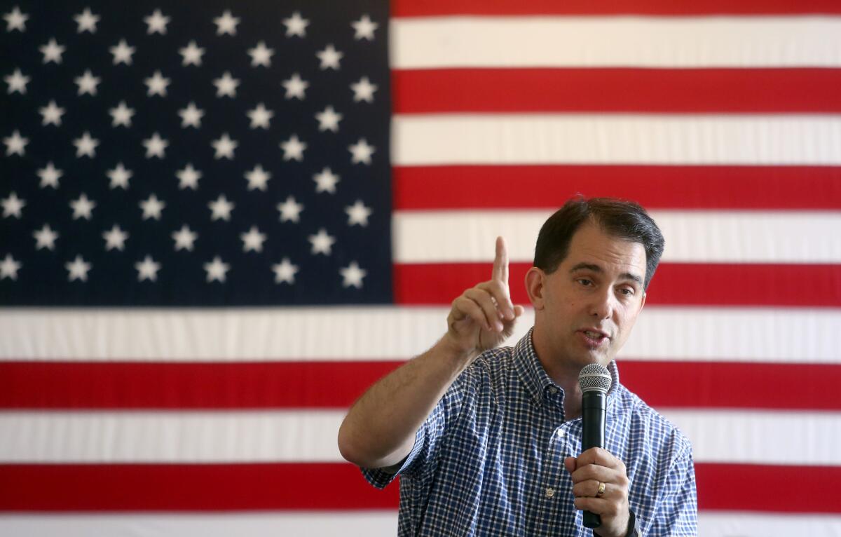 Wisconsin Gov. Scott Walker speaks to supporters Friday in Maquoketa, Iowa. He has opted out of his scheduled appearance next weekend at the California Republican convention.