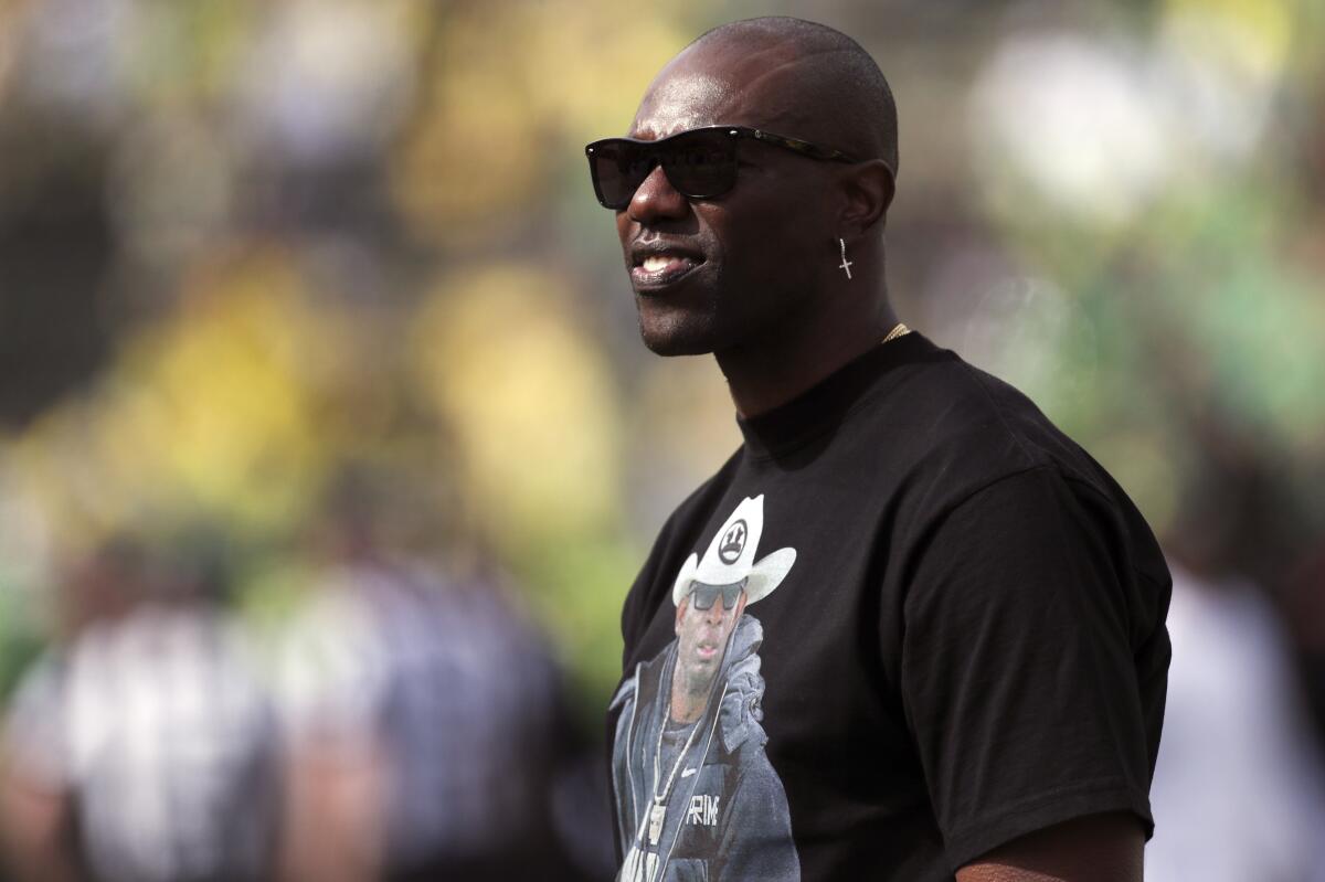  Terrell Owens looks on during warmups before a college football game.