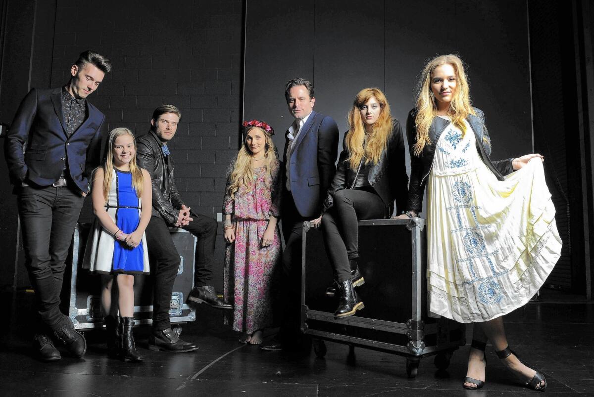 “Nashville” cast members Sam Palladio, left, Maisy Stella, Chris Carmack, Clare Bowen, Charles Esten, Aubrey Peeples and Lennon Stella gather backstage.