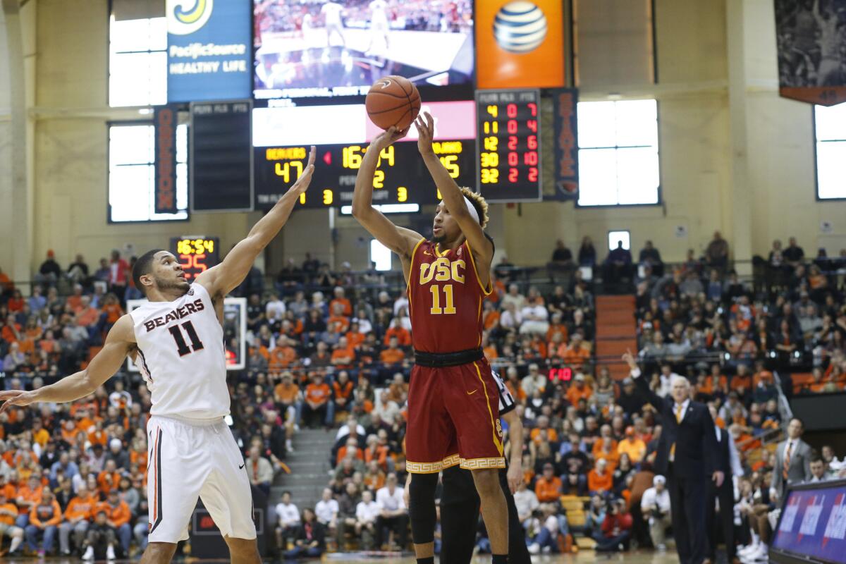 USC guard Jordan McLaughlin (11) shoots over Oregon State guard Malcolm Duvivier (11) in the second half.