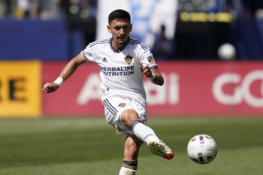 Los Angeles Galaxy midfielder Mark Delgado (8) shoots during an MLS soccer match.