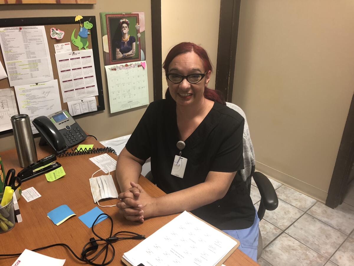 Melissa Tovar sits an office desk