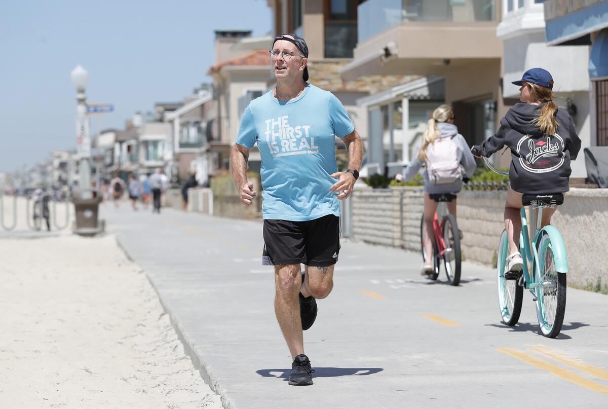Damon Brown runs along the bike path Wednesday in Newport Beach.
