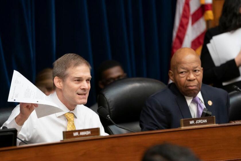 Rep. Jim Jordan, left, the House Oversight and Reform Committee's ranking Republican, delivers an opening statement in opposition to Chairman Elijah Cummings, D-Md., right, as Cummings calls for subpoenas after a career official in the White House security office says dozens of people in President Donald Trump's administration were granted security clearances despite "disqualifying issues" in their backgrounds, on Capitol Hill in Washington, Tuesday, April 2, 2019. The issue sets the stage for another fight between the White House and the Democratic-controlled House. (AP Photo/J. Scott Applewhite)