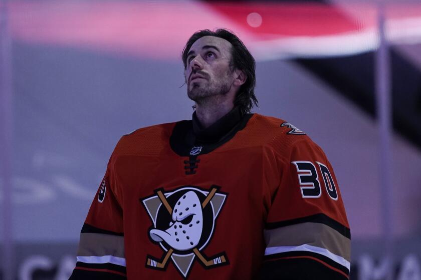 Anaheim Ducks goaltender Ryan Miller listens to the national anthem before the team's NHL hockey game.
