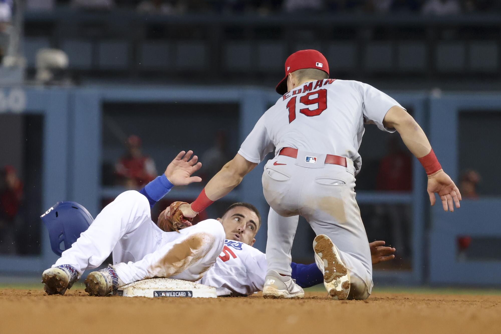 Los Angeles Dodgers' Cody Bellinger steals second base ahead of the tag by St. Louis Cardinals' Tommy Edman