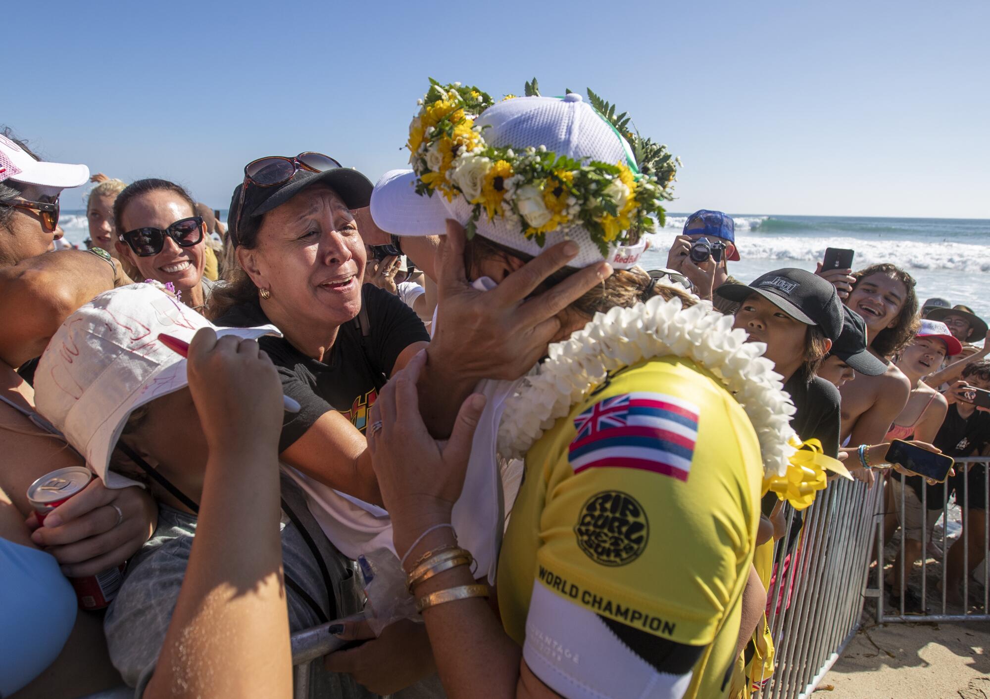 Carissa Moore gets a hug and lei from her mother, Carol Lum, after winning her fifth WSL title