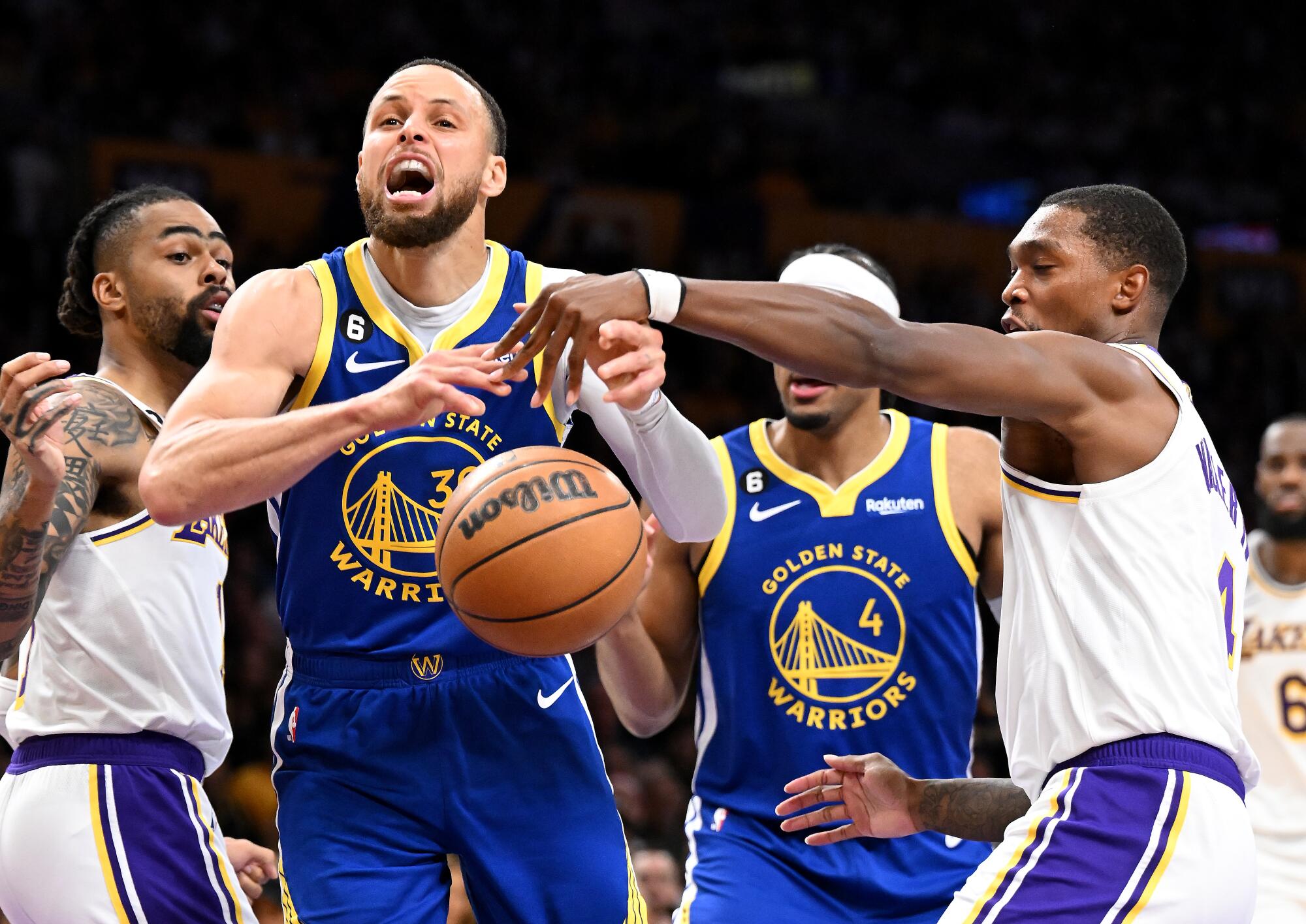 Lakers guard Lonnie Walker IV, right, strips the ball away from Stephen Curry in the second quarter.