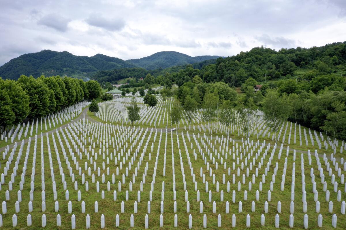 Gravestones are lined up at the memorial cemetery in Potocari, near Srebrenica, Bosnia, Tuesday, July 7, 2020. A quarter of a century after they were killed in Sreberenica, eight Bosnian men and boys will be laid to rest Saturday, July 11. Over 8,000 Bosnian Muslims perished in 10 days of slaughter after the town was overrun by Bosnian Serb forces in the closing months of the country’s 1992-95 fratricidal war. (AP Photo/Kemal Softic)