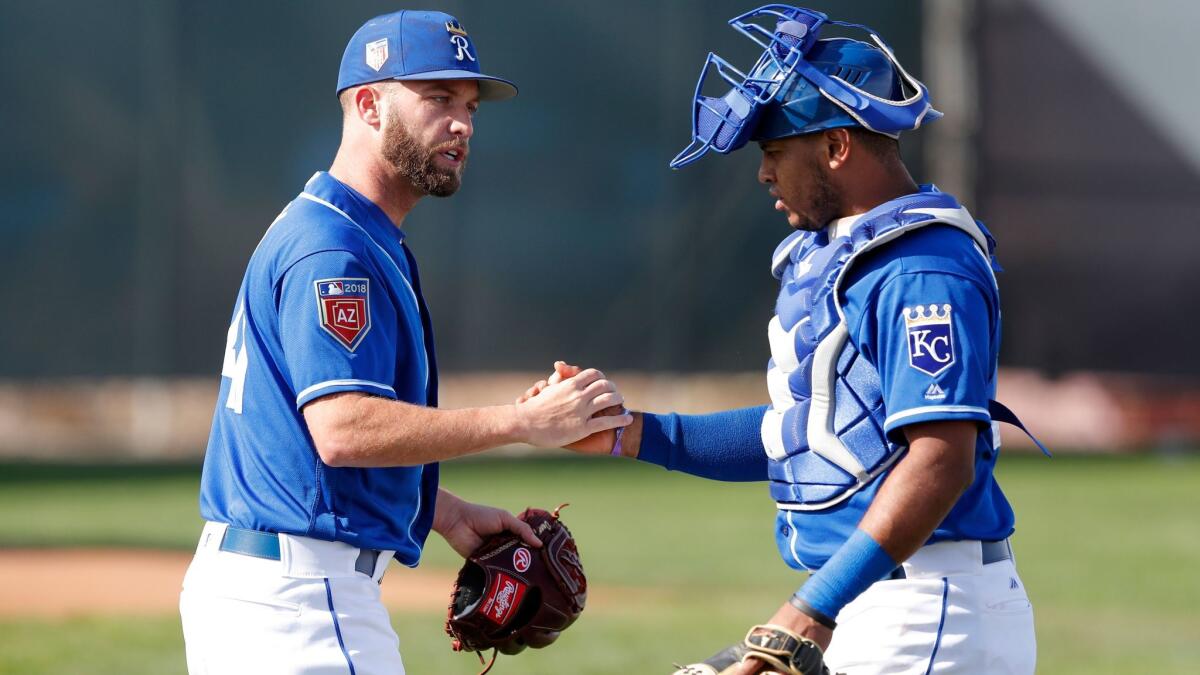 Royals starting pitcher Danny Duffy, left, talks with catcher Meibrys Viloria during a baseball spring training workout, Saturday, Feb. 17, 2018, in Surprise, Ariz.